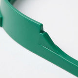 Close-up of the tabletop soccer game's green plastic sidewall, showing its curved edge and molded ridge against a white background.