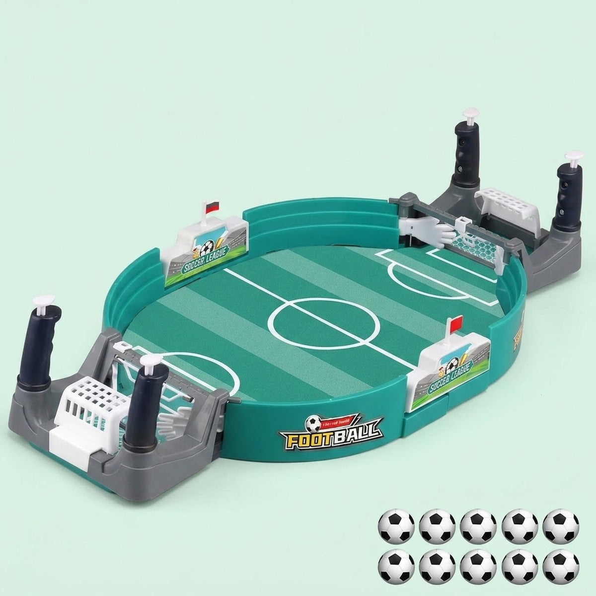 Green tabletop soccer game with gray goals and ten balls arranged in two rows beside it against a pale mint background.