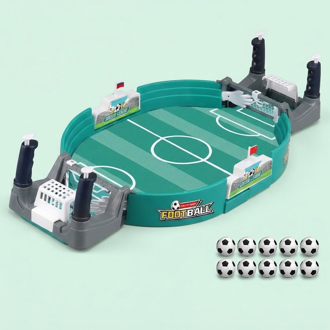 Green tabletop soccer game with gray goals, four black handles, and ten black-and-white balls on a pale mint background.