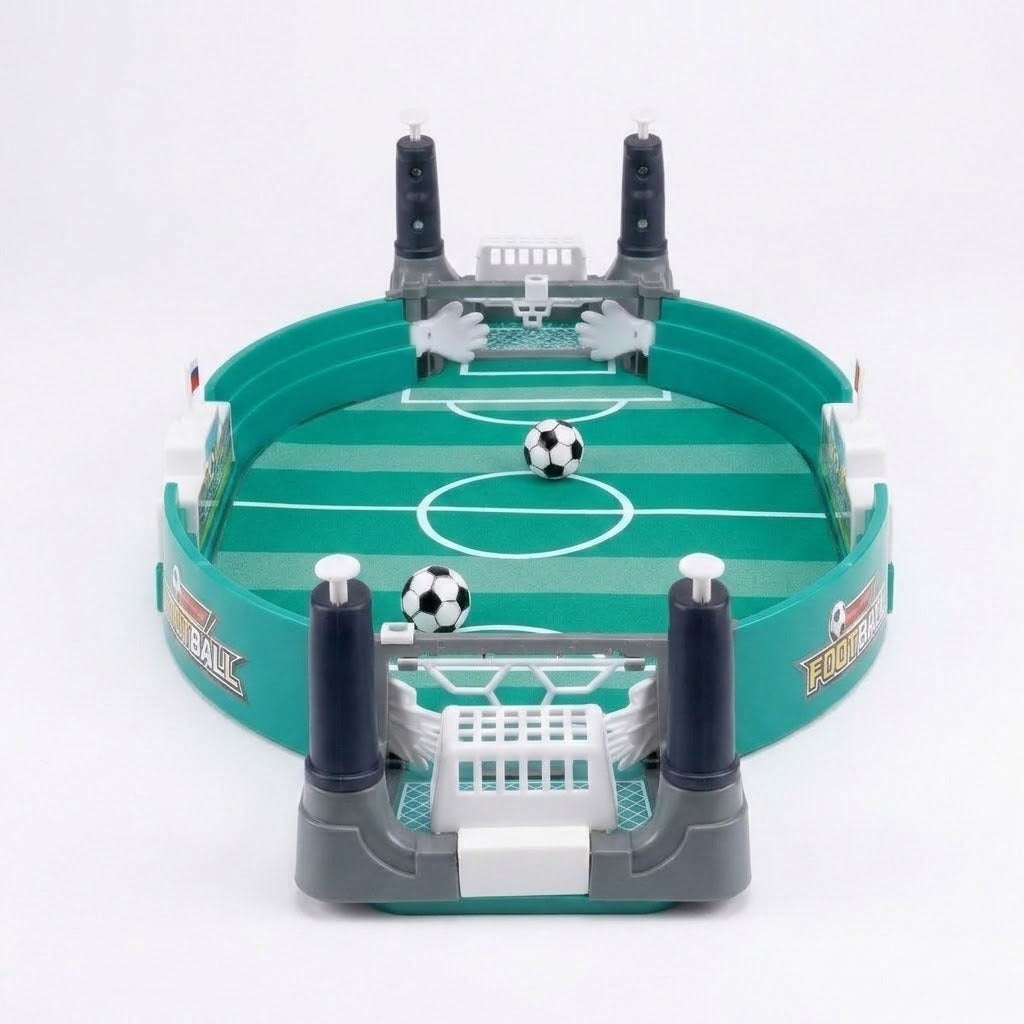 A green and grey tabletop soccer game with white goal nets, dark blue control handles, and two mini footballs on a white background.