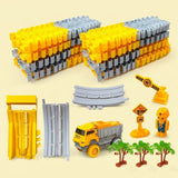 Yellow and gray race track set with stacked plastic sections, a dump truck, worker figure, and palm trees on a pale yellow background.