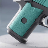 A close-up shows the water gun's textured turquoise grip, circular grey inset, and grey frame against a muted grey background.