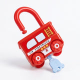 A red firetruck-shaped lock puzzle has an open shackle and an inserted pale blue key against a white background.