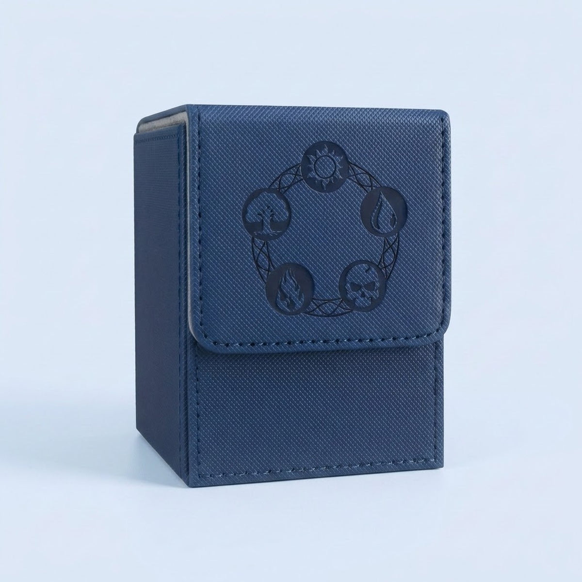 Blue textured card deck box with gray lining, stitched edges, and dark embossed symbols on its front flap against a pale blue background.