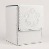 White textured card deck box with gray lining, stitched edges, and embossed circular symbols on its front flap against a pale background.