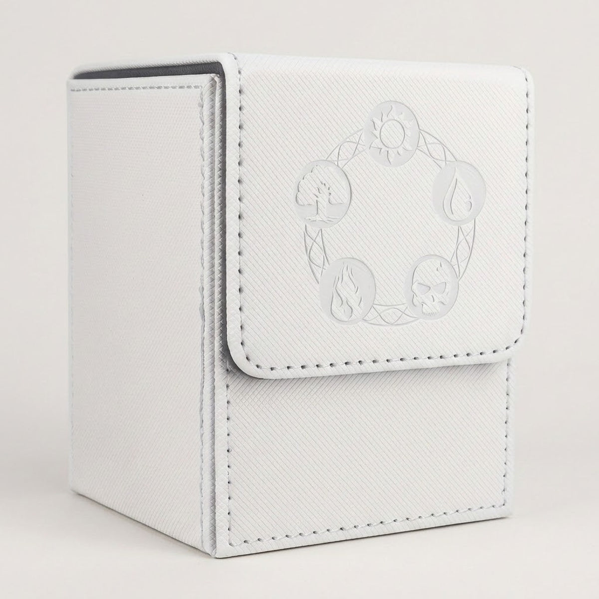 White textured card deck box with gray lining, stitched edges, and embossed circular symbols on its front flap against a pale background.
