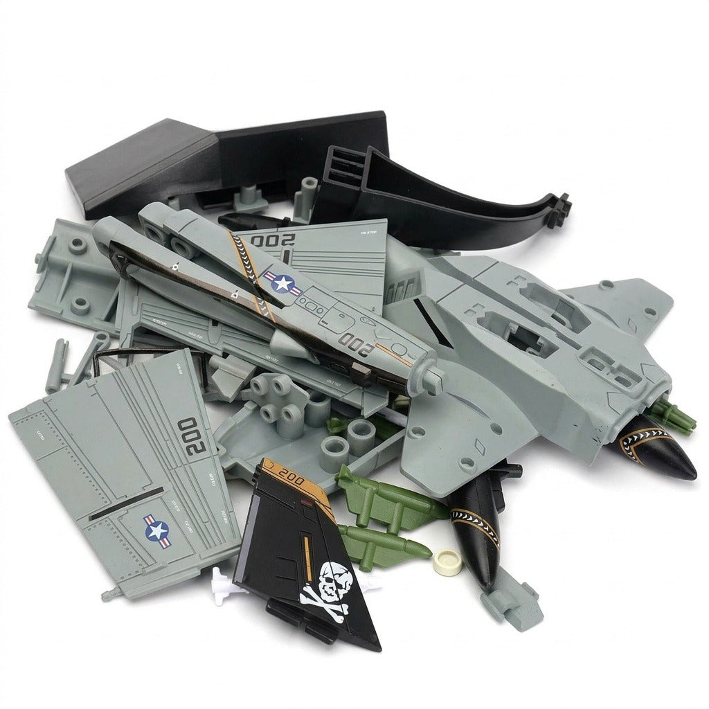 Unassembled aircraft model kit with gray plastic wings, black pirate tail fins, and green accessories piled on a white background.
