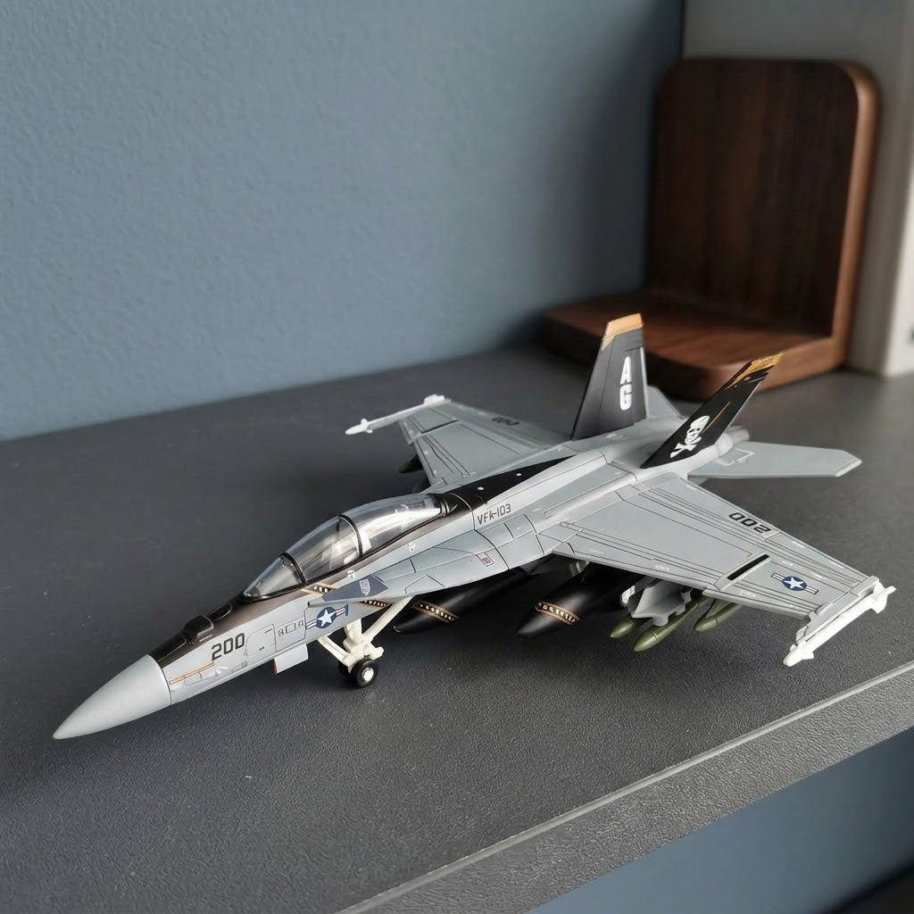 Assembled gray plastic aircraft model kit with black pirate tail fins displayed on a dark shelf beside a blue wall and wooden bookend.
