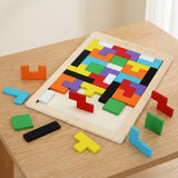 A partially completed wooden tangram puzzle with brightly colored blocks and scattered loose pieces rests on a wooden table.