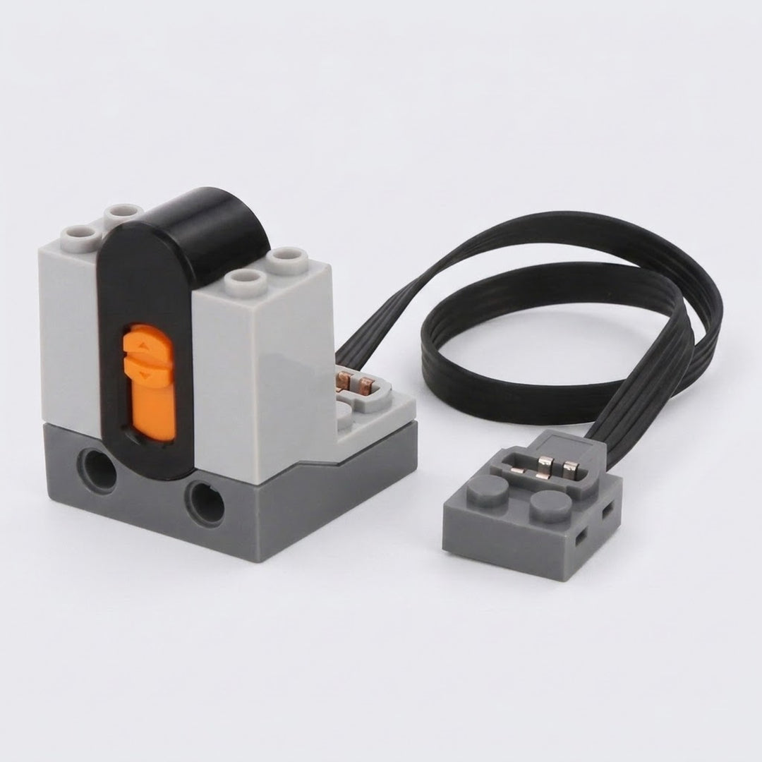 A LEGO-compatible electrical relay module with a black and gray plastic body, an orange switch, and a black wire connector, shown on a light gray background.