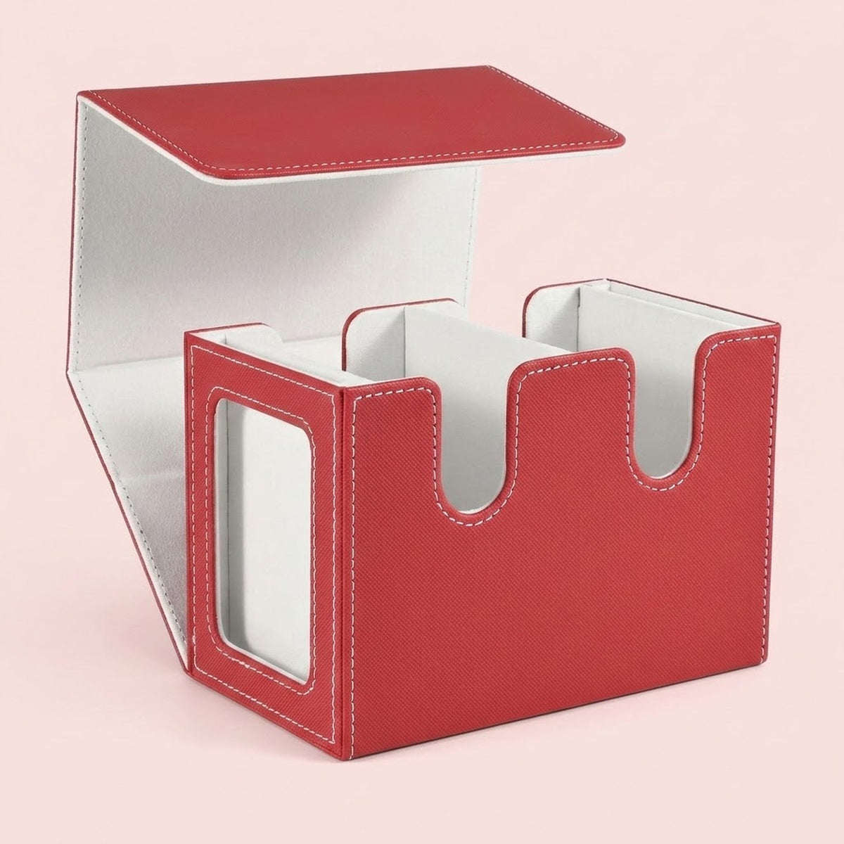 Red textured deck box with white lining stands open on a pale pink background, showing two compartments and a side display window.