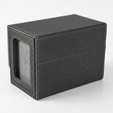 A closed black deck box shows its wraparound cover, white stitching, and gray-backed side display window against a light background.