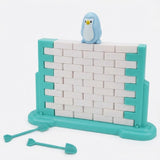 A turquoise and white balance game stands fully assembled with a blue penguin on top and two turquoise tools against a white background.