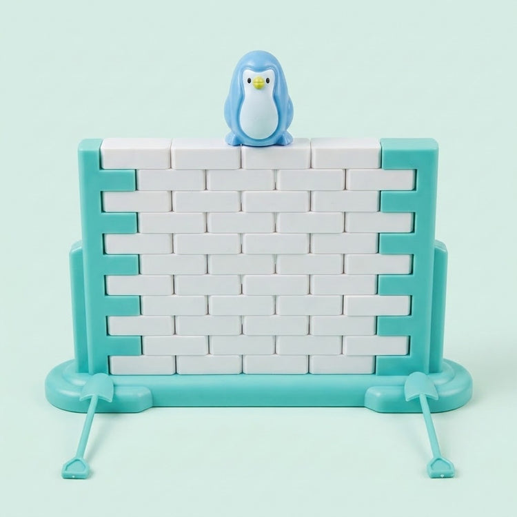 Single-piece penguin balance game with a blue penguin atop a white block wall in a turquoise frame against a pale mint background.