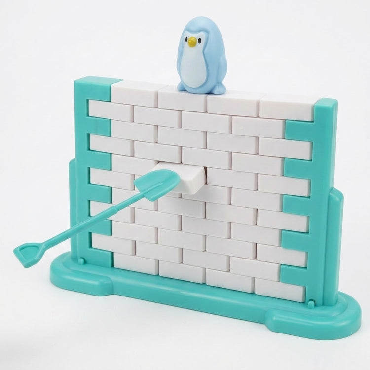 A turquoise tool pushes a white block from the balance game beneath a blue penguin, with a turquoise frame against a white background.