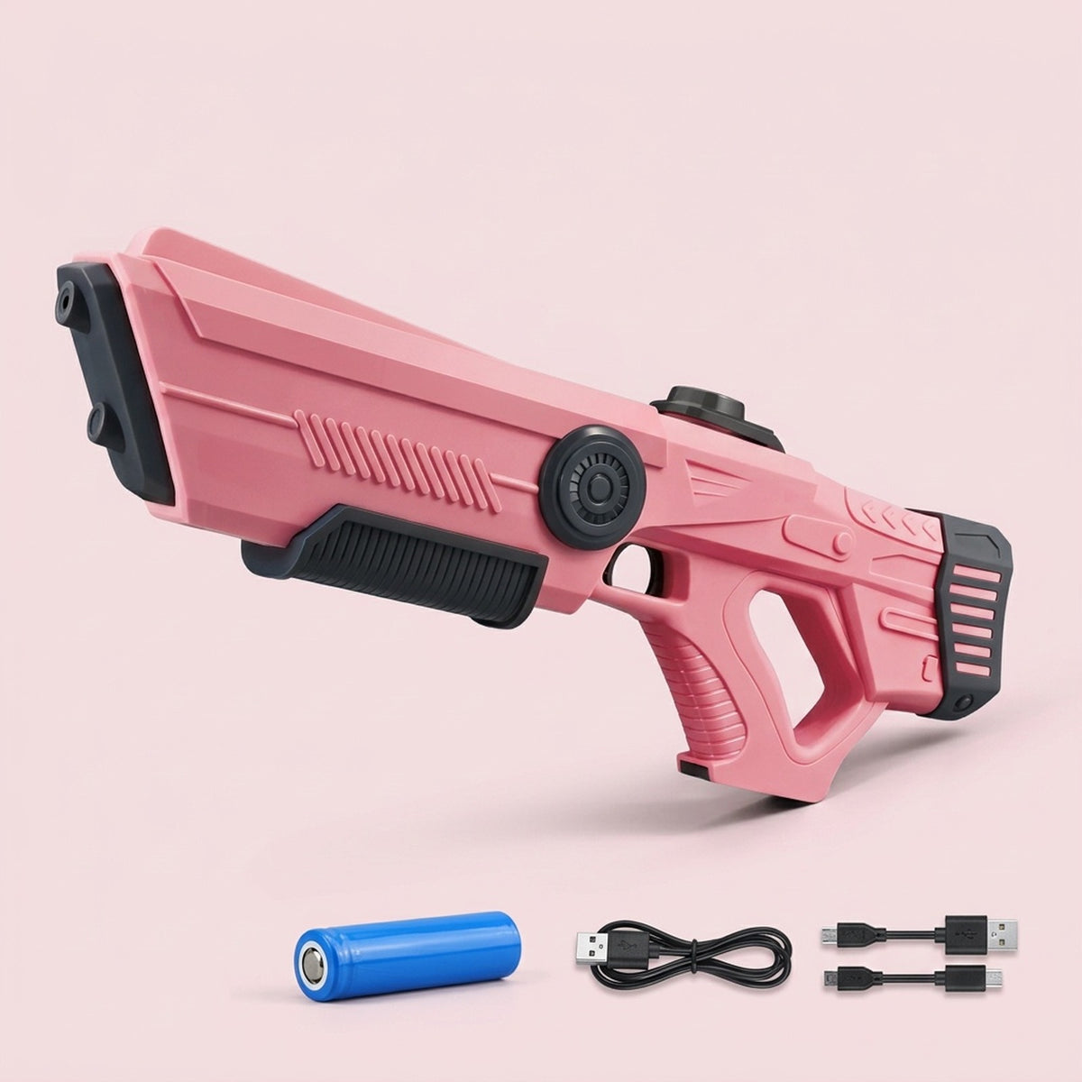 Pink water gun with ribbed detailing and black accents on a pale pink background, beside a blue battery and black USB cables.