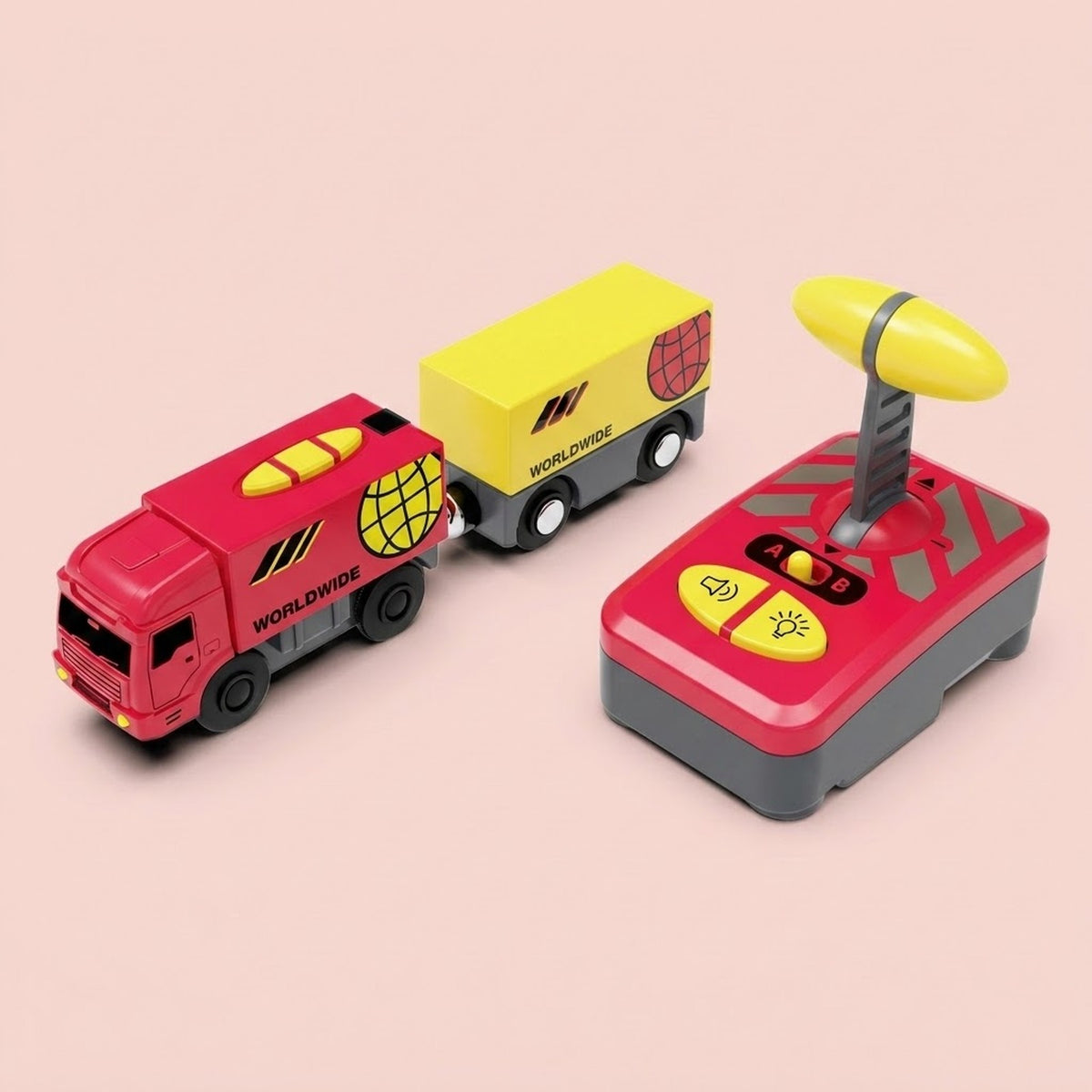 Truck-shaped red toy train with a yellow carriage and red-and-yellow remote controller on a pale pink background.
