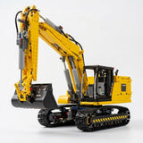 Yellow and black plastic excavator building set assembled with crawler tracks and an articulated boom against a white background.