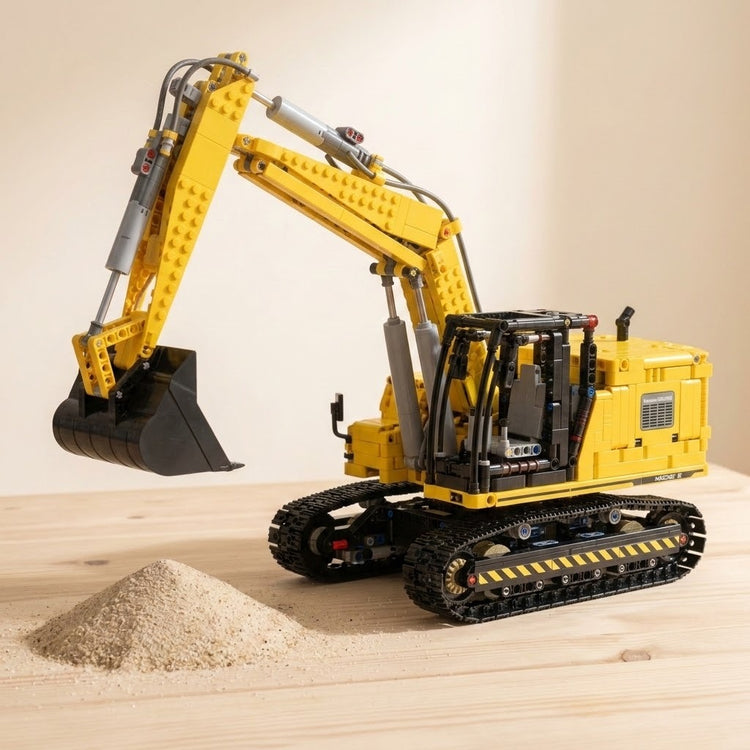 Yellow and black plastic excavator building set assembled with its bucket raised beside a small sand pile on a wooden tabletop.