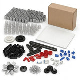 V8 engine model kit with unassembled multicolored plastic connectors, gears and fan pieces arranged beside a booklet and cardboard box.