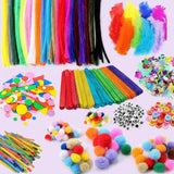 A colorful craft kit arranged on a light lavender background, including rainbow pipe cleaners, rainbow popsicle sticks, feathers, pom-poms, buttons, googly eyes, and paper circles.