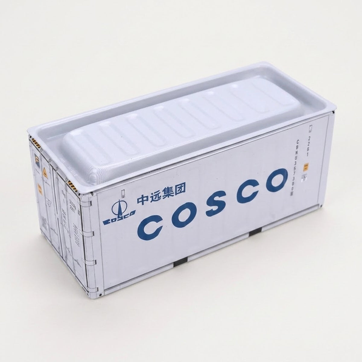 A white metal storage box with spaced navy lettering and a recessed lid sits against an off-white background.