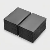 Two stacks of dark gray matte polypropylene card sleeves sit side by side on a light gray background.