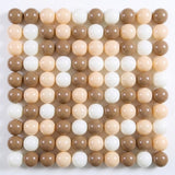 Glossy plastic ball pit balls in mocha brown, cream, and white form a square grid on a white background.