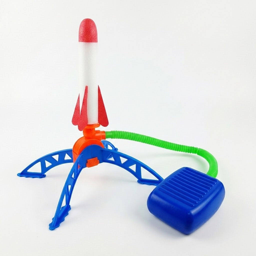 Rocket launcher with blue plastic stand and foot pump, green hose, and one red-and-white foam rocket on a white background.