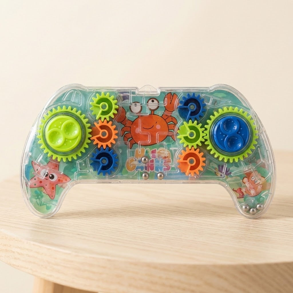 Transparent plastic controller-shaped maze puzzle with colorful gears and sea creature illustrations rests on a round wooden table.