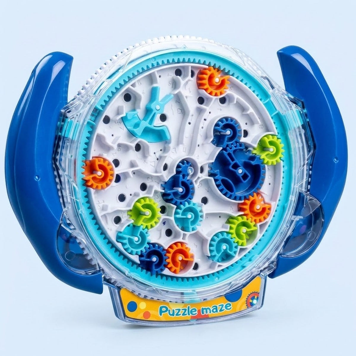 A circular plastic toy puzzle maze with blue side handles and colorful rotating gears, labeled 'Puzzle maze' on a light blue background.