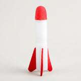 A single red-and-white foam rocket for the rocket launcher stands upright on its red fins against a light gray background.