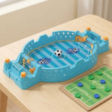 Blue tabletop soccer game with yellow controls and a miniature ball sits beside a green token board on a wooden table.