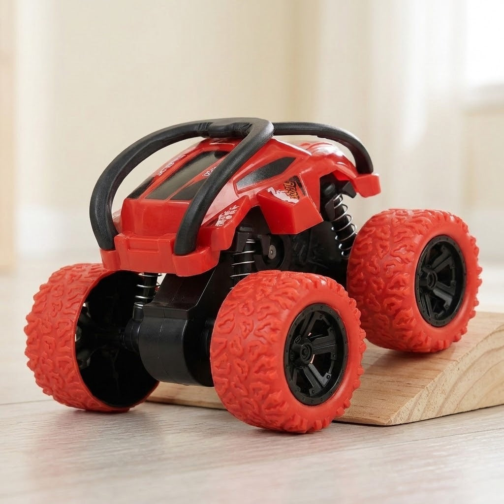 Red toy car with black protective bars and oversized treaded wheels sits partly on a wooden ramp against a cream background.