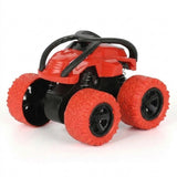 Red toy car with a black chassis, curved protective bars, and oversized red wheels stands against a white background.