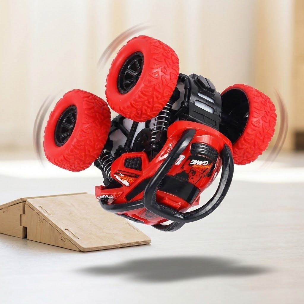 Red and black toy car appears upside down in midair beside a wooden ramp, with curved motion effects around its wheels.