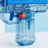 Close-up of a transparent blue plastic toy water gun with a bright blue top section and an orange trigger accent, shown against a pale blue and white background.