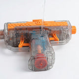 An orange and transparent water gun lies on a white surface while water pours into an opening in its grip.