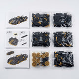 Car building kit with numbered bags of black and gold plastic pieces beside paper assembly instructions on a white background.