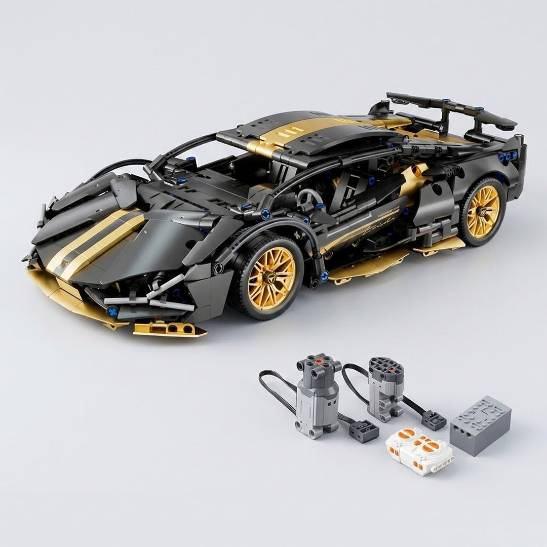 Assembled black and gold car building kit sits behind two wired motors, a white controller, and gray component on a light gray background.