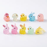 Ten translucent resin miniature animal and mushroom figurines in pink, yellow, blue and pale green stand in two rows against white.