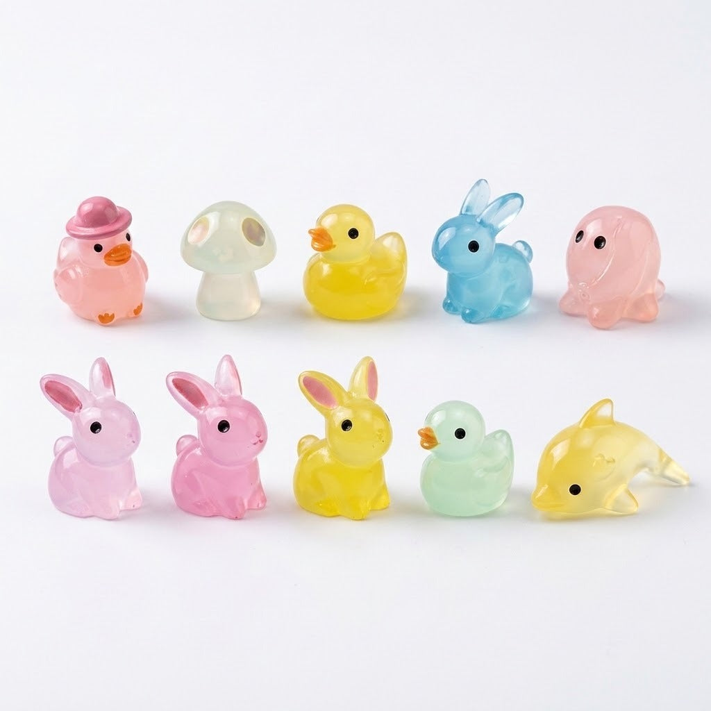 Ten translucent resin miniature animal and mushroom figurines in pink, yellow, blue and pale green stand in two rows against white.