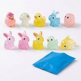 Ten translucent pastel resin miniature figurines shaped like animals and a mushroom stand behind a blue blind bag on a white background.