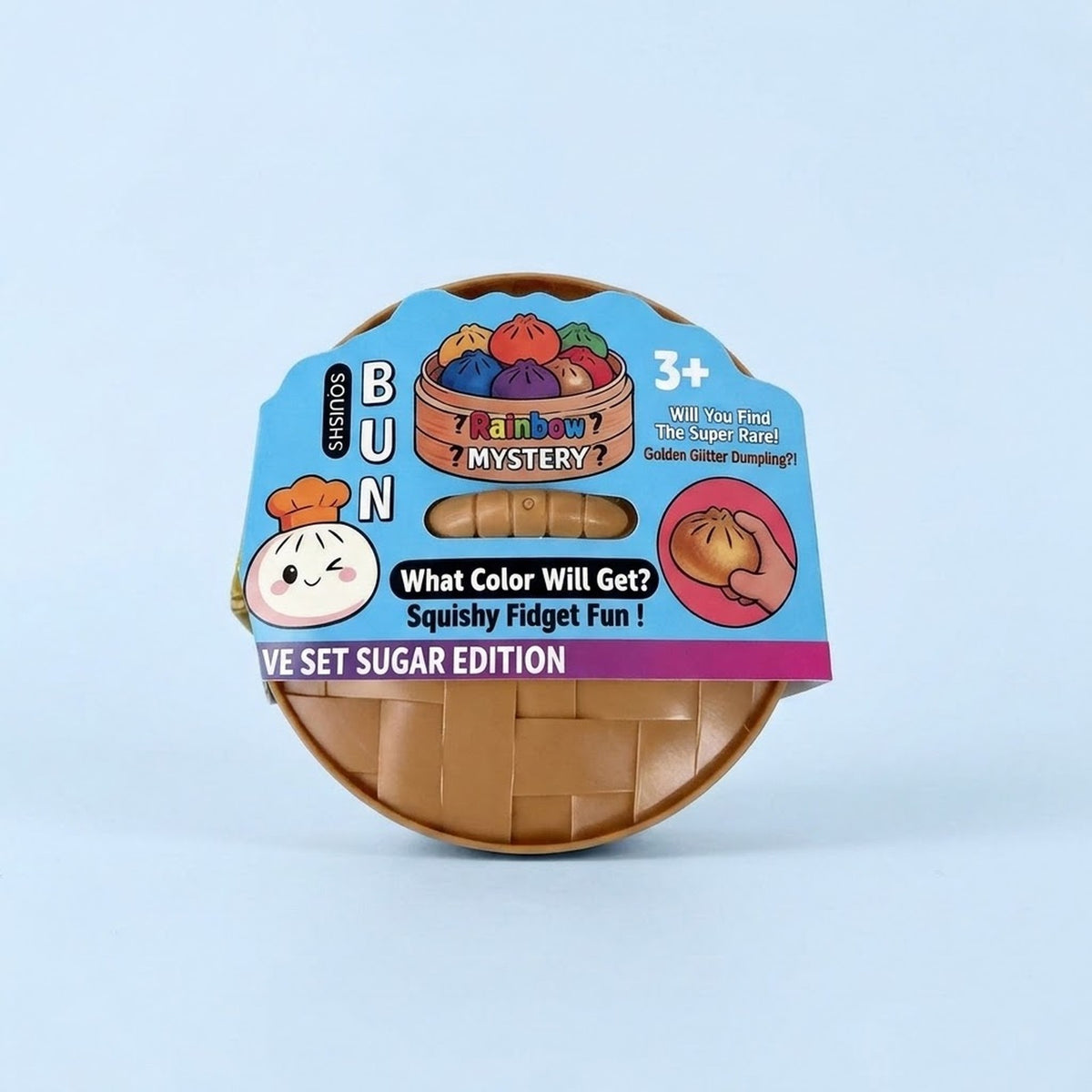 A round plastic toy container with a colorful printed label reading 'BUN' and 'Mystery', showing a brown squishy fidget inside, photographed on a light blue background.