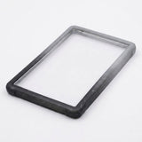 Black-gray slab bumper lies diagonally on a white background, showing its empty rectangular center and speckled edges.
