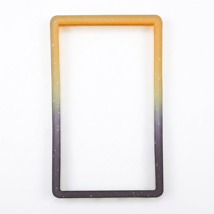 Orange-black slab bumper with pale speckles and an empty rectangular center rests on a white background.