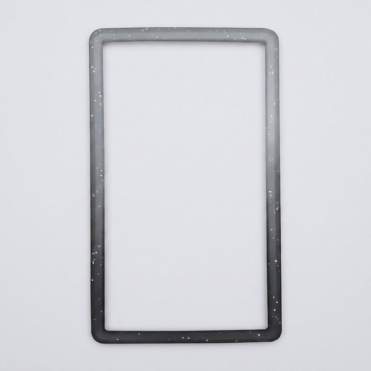 A speckled gray-to-black silicone TPU slab bumper lies flat on a light gray background with its open center visible.