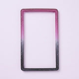 A purple-to-black silicone TPU slab bumper with white speckles lies flat on a pale lavender background.