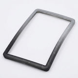 A speckled gray-to-black silicone TPU slab bumper lies diagonally on a white background, showing its open center and rounded corners.