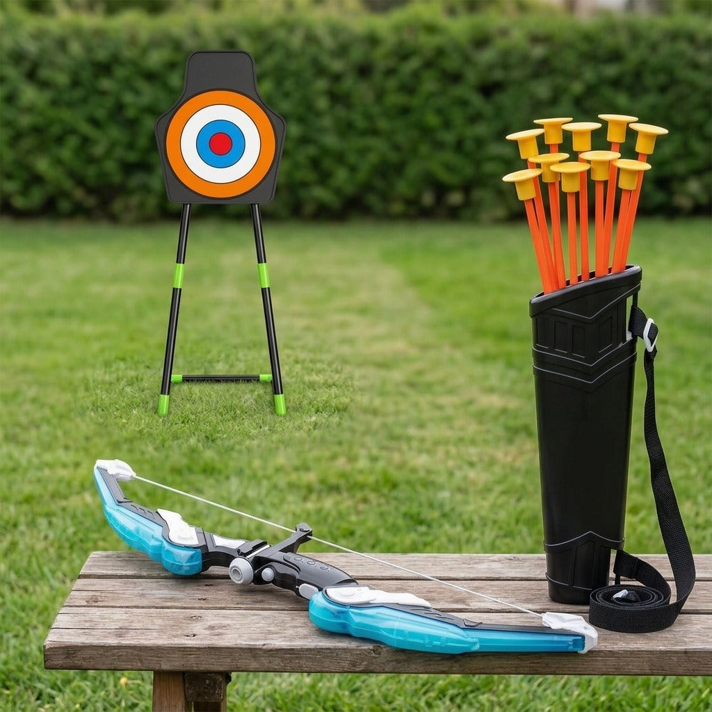A toy bow and arrow set displayed outdoors on a wooden bench, with a black archery target on a stand in the background and a black quiver holding orange arrows with yellow tips on the right.